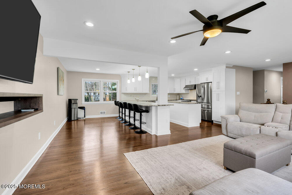 37 Glenbrook Road Freehold, NJ 07728 - Photo 5 of 34 a living room with furniture kitchen view and a wooden floor