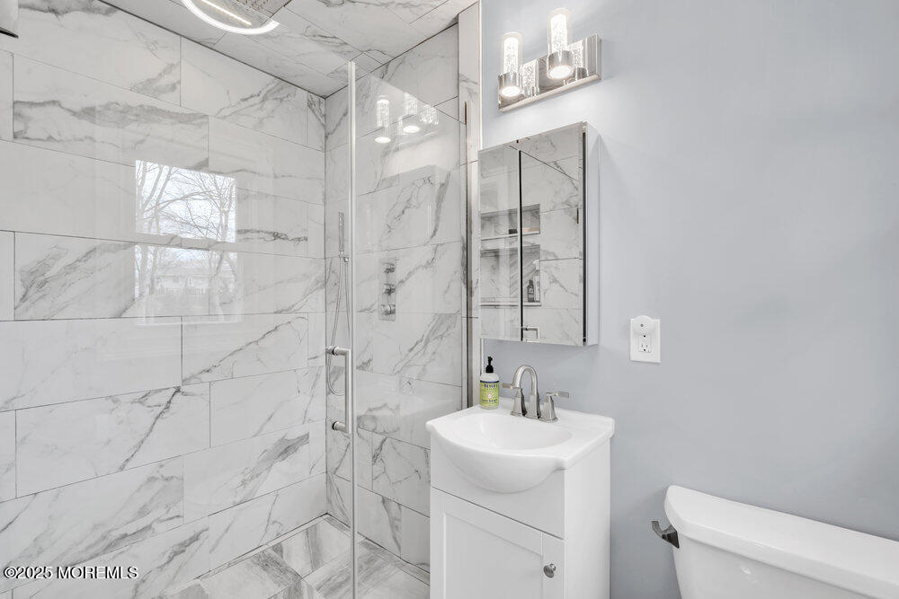 37 Glenbrook Road Freehold, NJ 07728 - Photo 9 of 34 a bathroom with a sink a toilet and shower