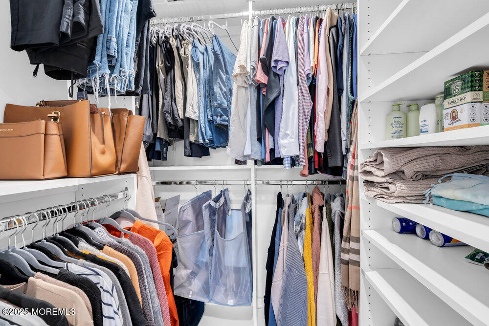 37 Glenbrook Road Freehold, NJ 07728 - Photo 10 of 34 a view of walk in closet with clothes and shoes