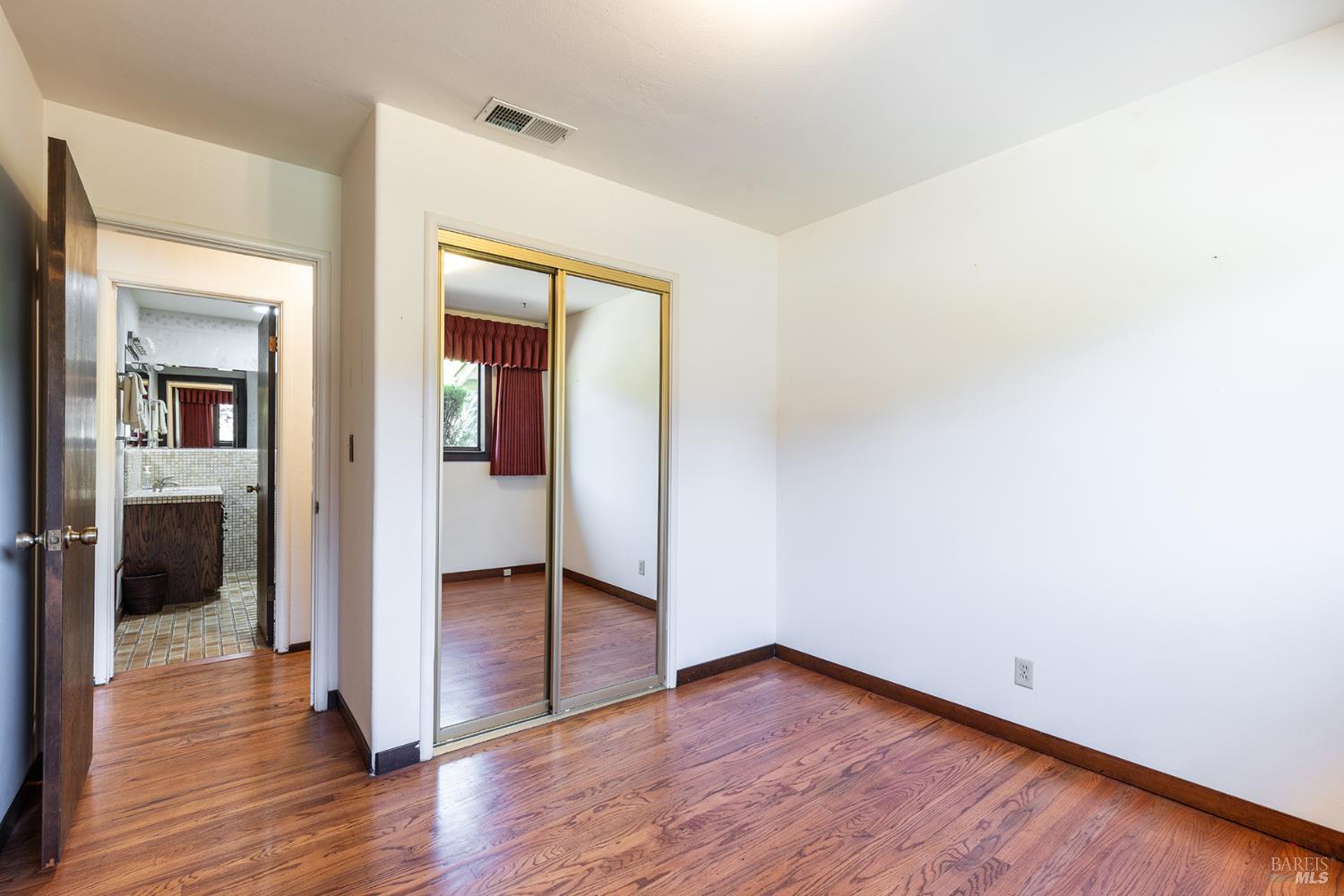 2236 West Hearn Avenue Santa Rosa, CA 95407 - Photo 28 of 56 an empty room with wooden floor and a bathroom