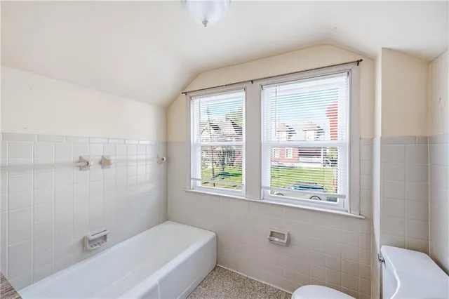 a bathroom with a bathtub and window