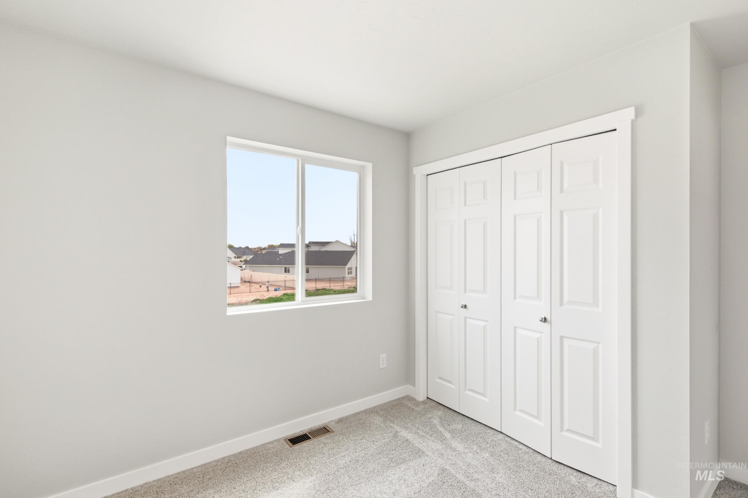 2446 West Fallon Loop Nampa, ID 83651 - Photo 13 of 19 Unfurnished bedroom featuring light colored carpet and a closet