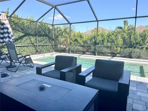a view of a patio with table and chairs under an umbrella
