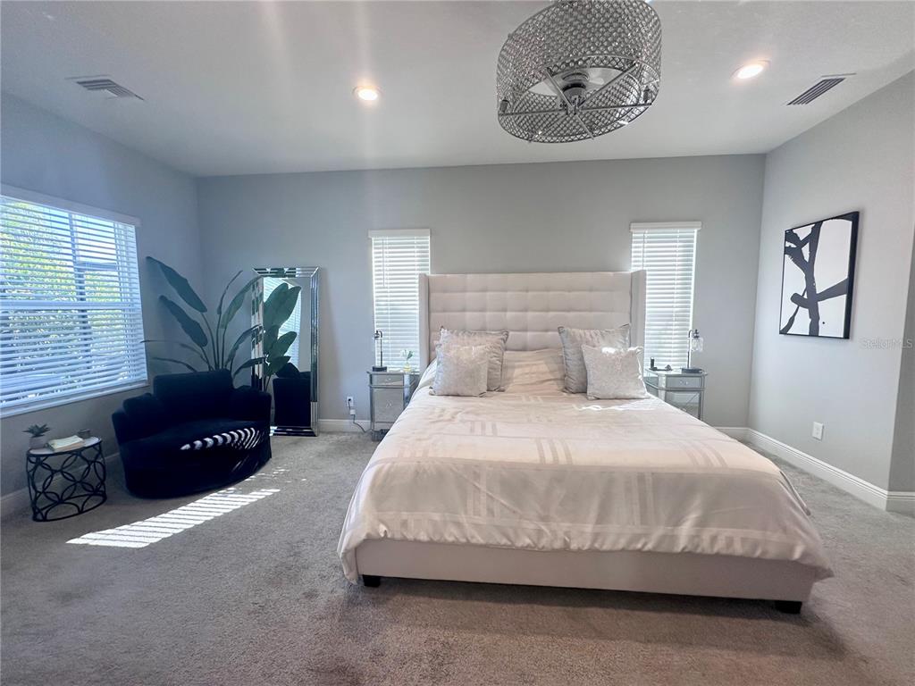 2716 Butterfly Jasmine Trail Sarasota, FL 34240 - Photo 14 of 27 a bedroom with a bed lamp and a window