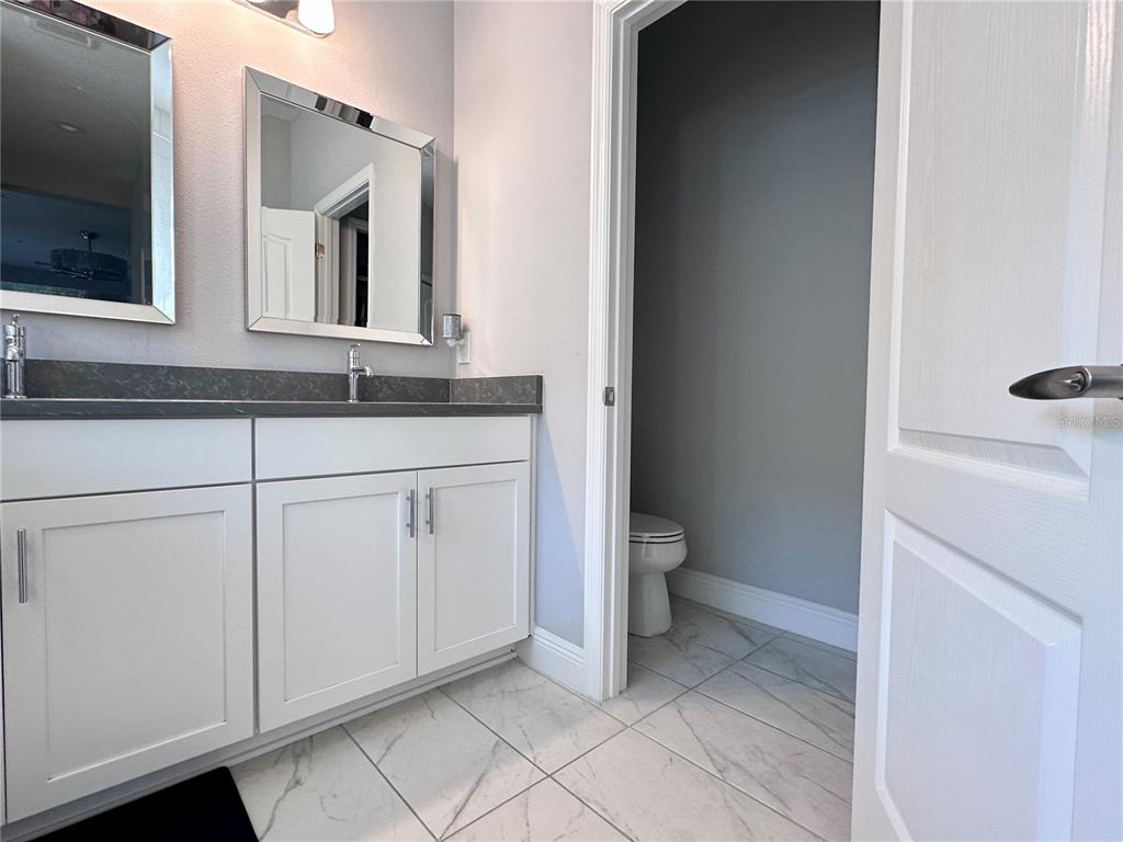 2716 Butterfly Jasmine Trail Sarasota, FL 34240 - Photo 16 of 27 a bathroom with a sink and a toilet