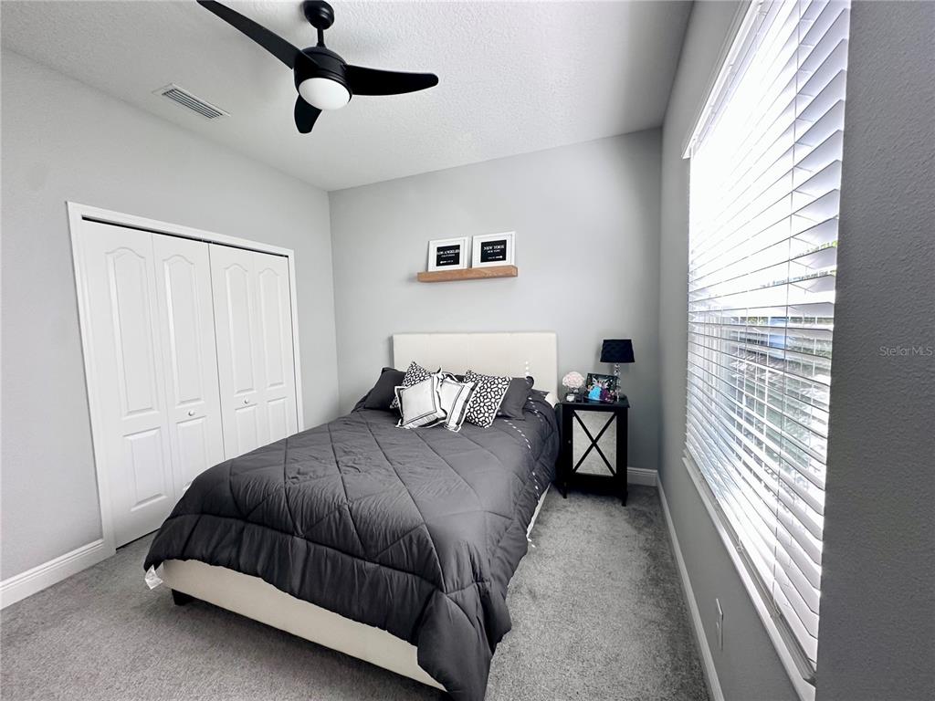 2716 Butterfly Jasmine Trail Sarasota, FL 34240 - Photo 19 of 27 a bedroom with a bed and a window