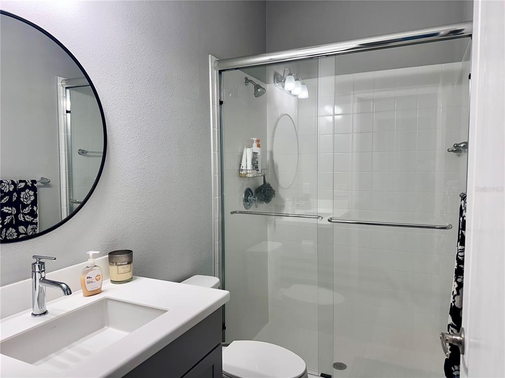 2716 Butterfly Jasmine Trail Sarasota, FL 34240 - Photo 20 of 27 a bathroom with a sink vanity mirror and toilet