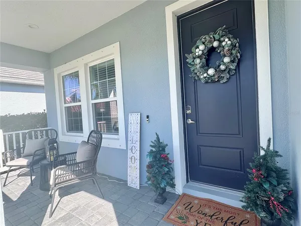 a living room with furniture and flowers