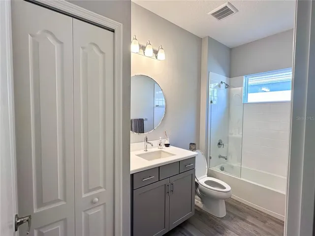a bathroom with a toilet a sink and a mirror