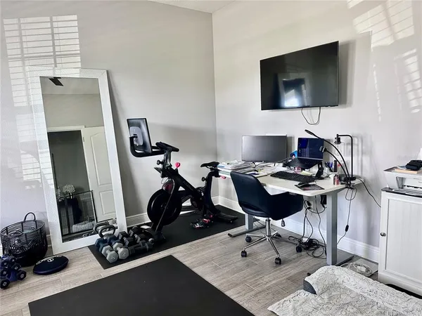 a view of a workspace with furniture and a flat screen tv