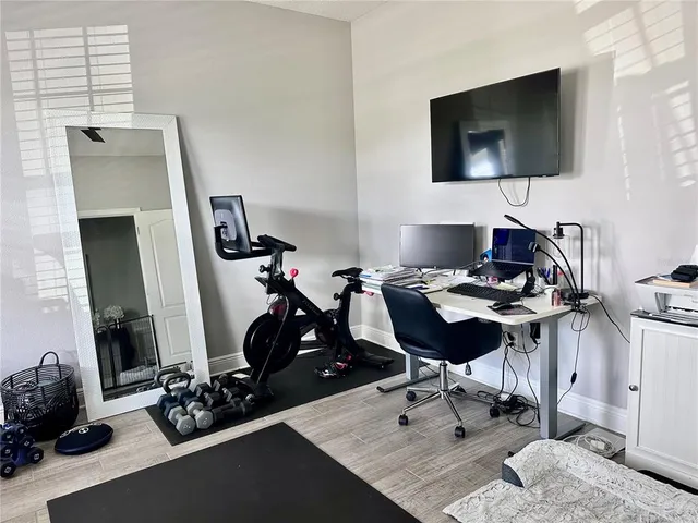 a view of a workspace with furniture and a flat screen tv