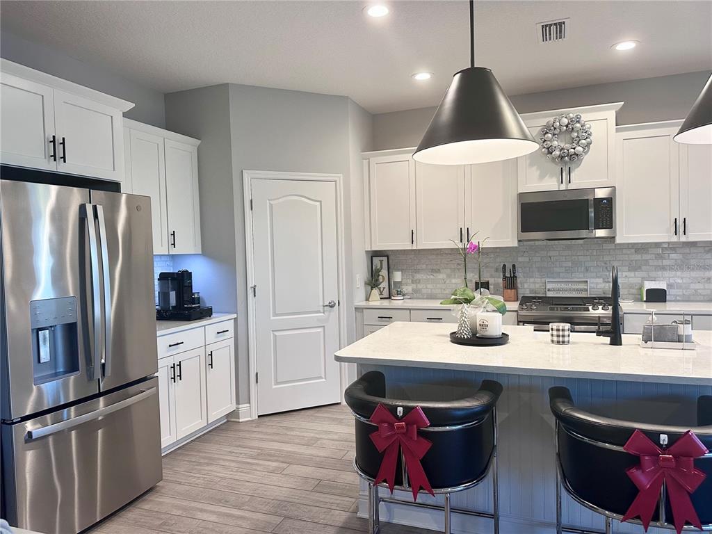 2716 Butterfly Jasmine Trail Sarasota, FL 34240 - Photo 5 of 27 a kitchen with stainless steel appliances a sink stove and refrigerator