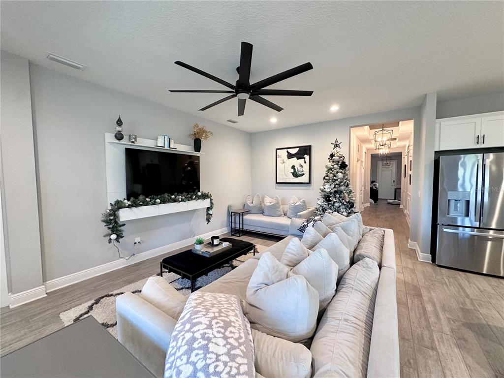 2716 Butterfly Jasmine Trail Sarasota, FL 34240 - Photo 9 of 27 a living room with furniture and a flat screen tv