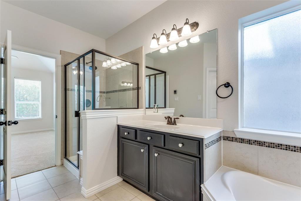 2344 Ranchview Drive Little Elm, TX 75068 - Photo 14 of 24 Bathroom featuring a dark wood vanity with white countertop, chrome fixtures, and a large mirror