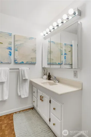 a bathroom with a double vanity sink mirror and