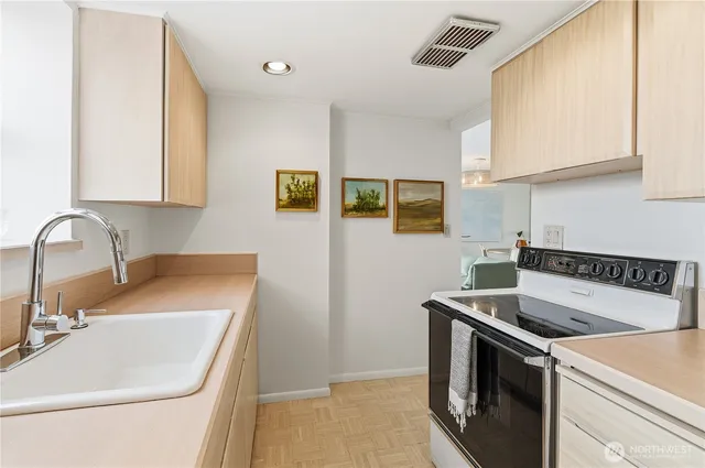 a kitchen that has a sink and a stove