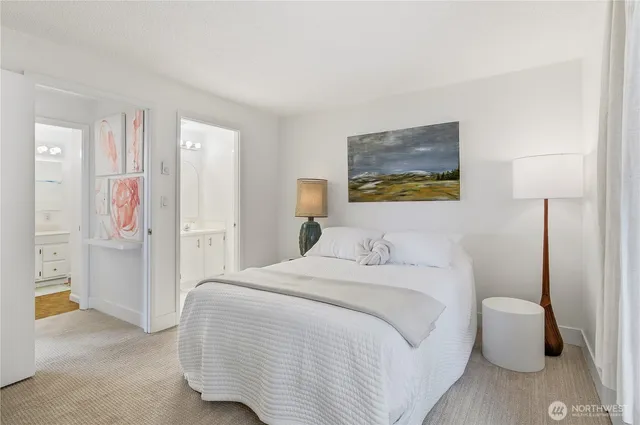 a bedroom with a bed and a painting on the wall