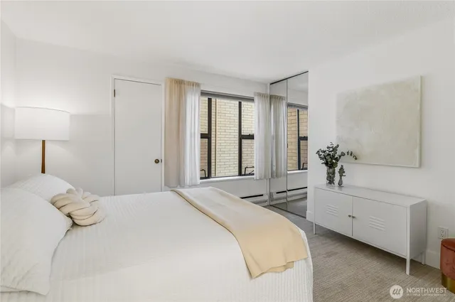 a bedroom with a bed and a window