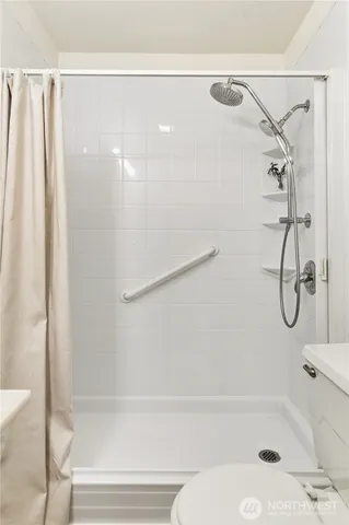 a bathroom with a shower and a bath tub