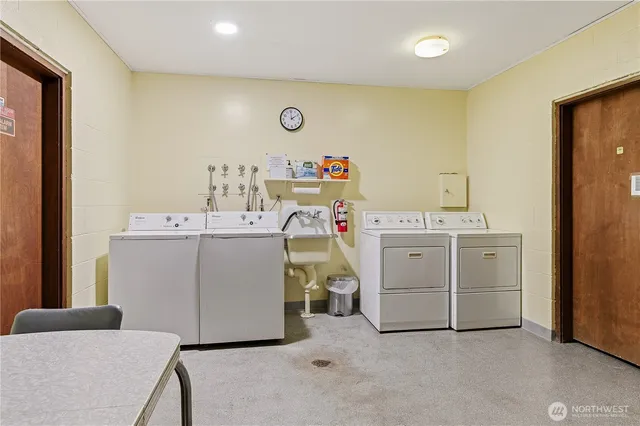 a utility room with a sink dryer and washer