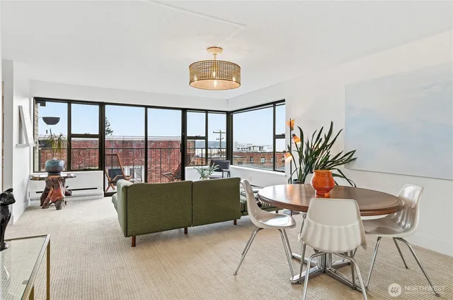 a living room with furniture and a floor to ceiling window