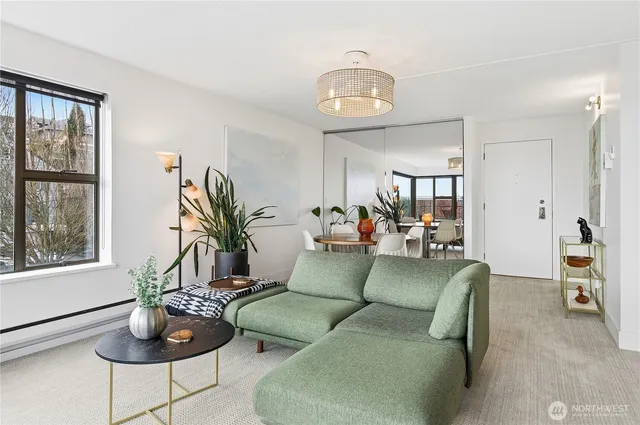a living room with furniture potted plant and a large mirror