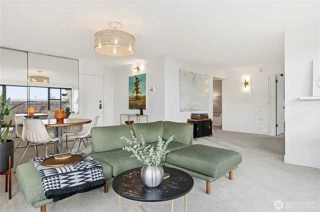 a living room with furniture and a chandelier