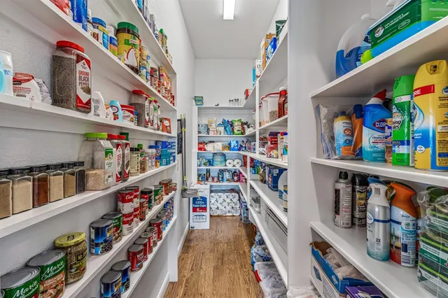 a spacious bedroom with a bed and a chandelier