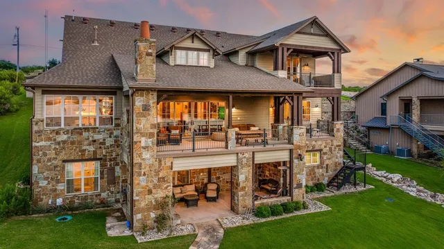 an aerial view of residential houses with outdoor space and lake view
