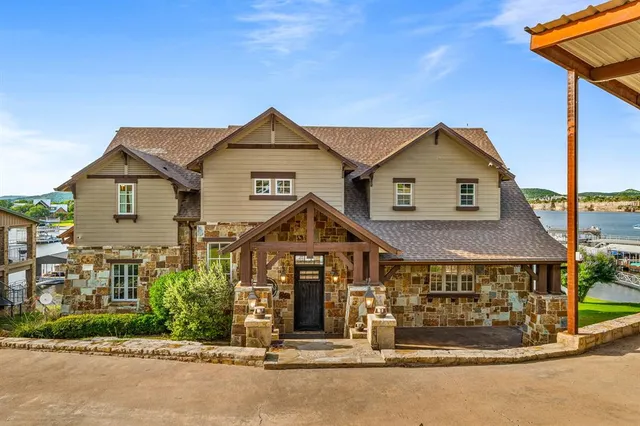 a view of patio with a table and chairs under an umbrella with a small yard