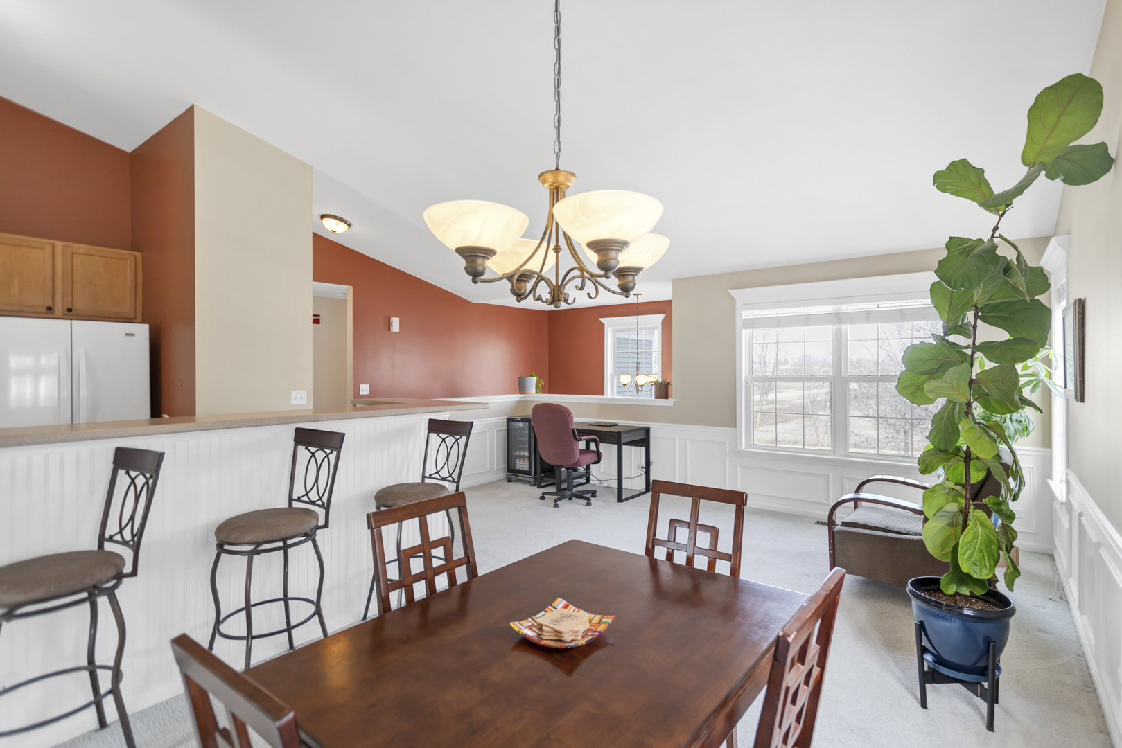 2574 Golf Ridge Circle Naperville, IL 60563 - Photo 11 of 29 a view of a dining room with furniture a potted plant and a chandelier