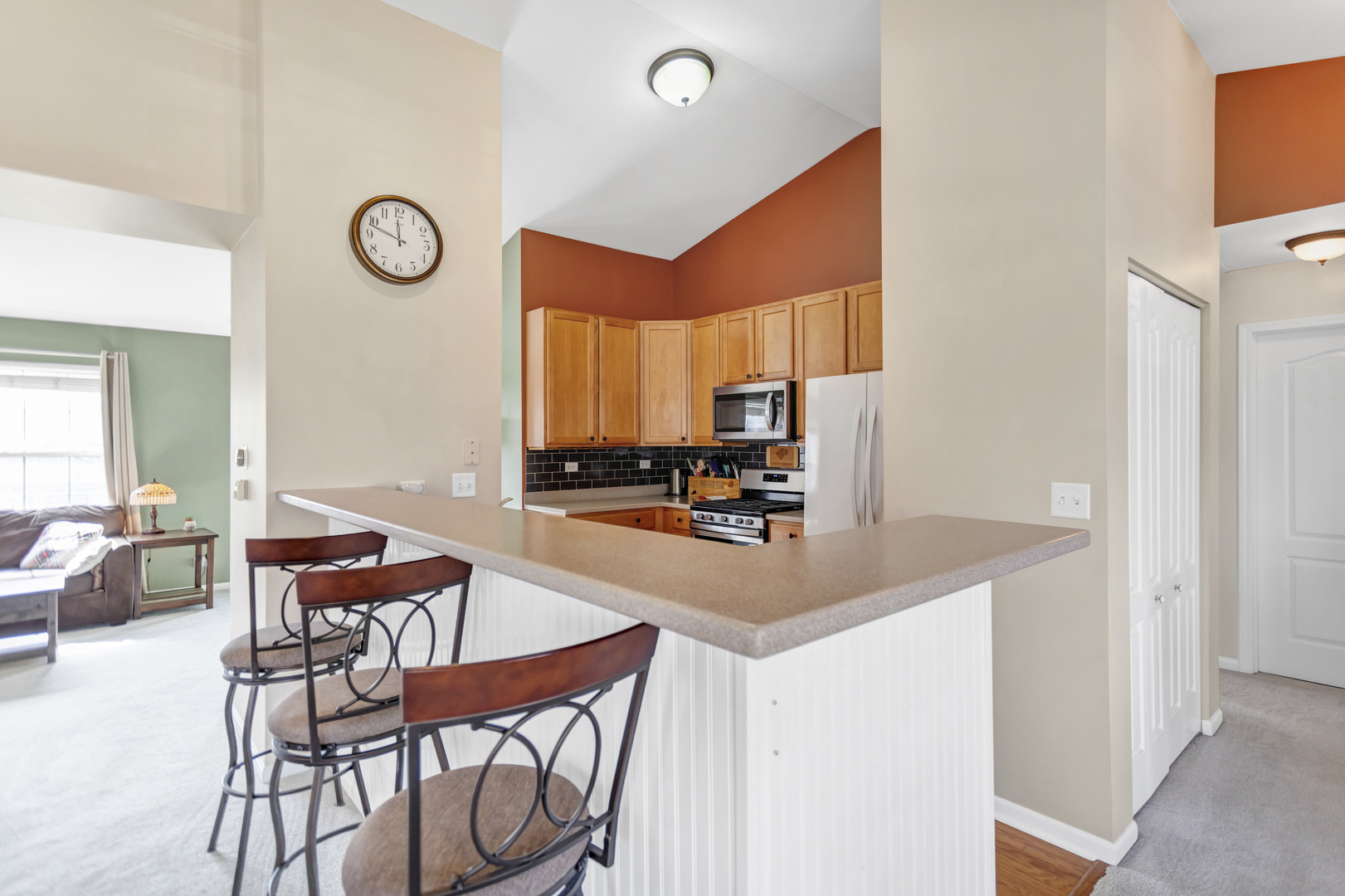 2574 Golf Ridge Circle Naperville, IL 60563 - Photo 12 of 29 a kitchen with stainless steel appliances a table and chairs in it