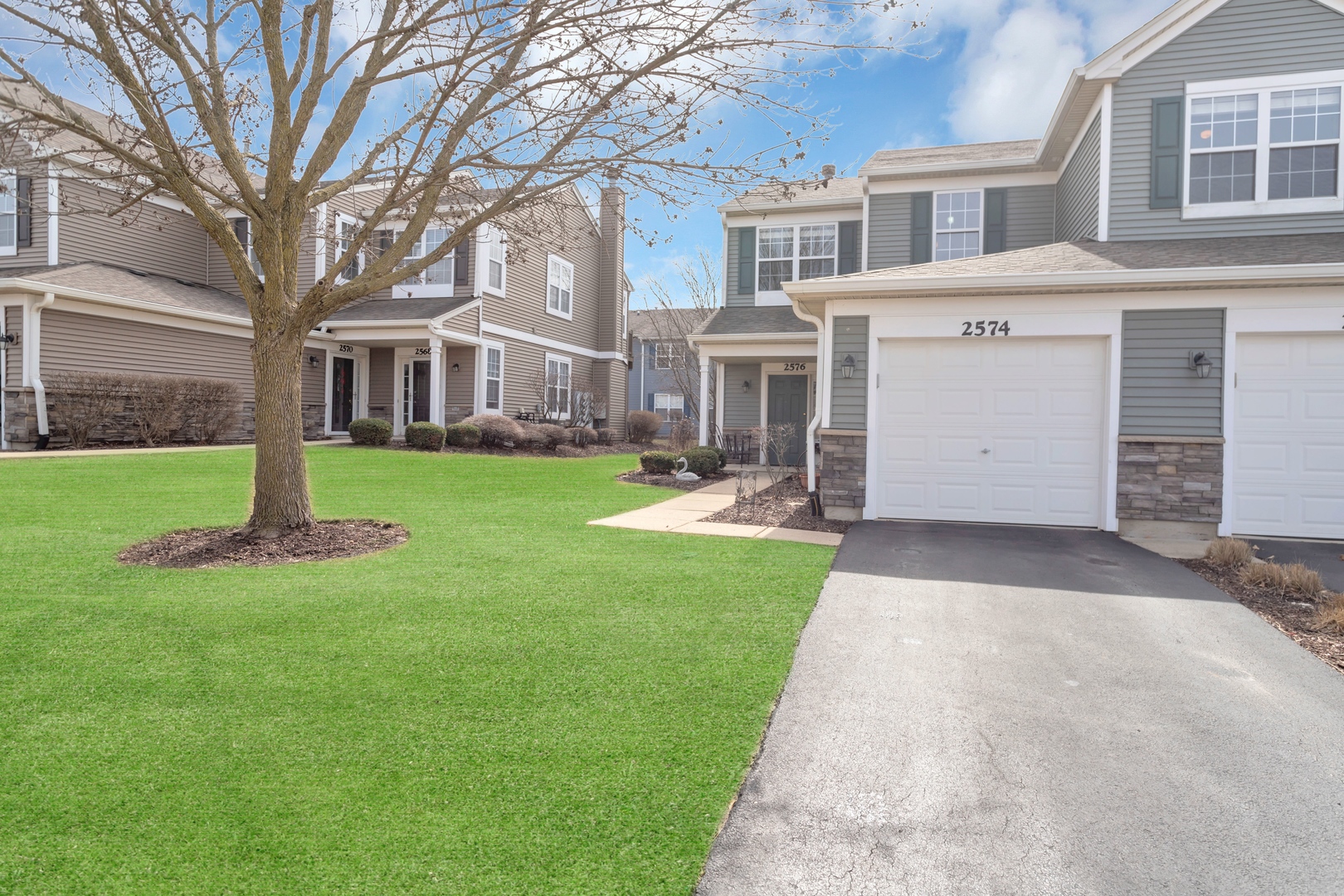 2574 Golf Ridge Circle Naperville, IL 60563 - Photo 2 of 29 a front view of a building with a garden and trees