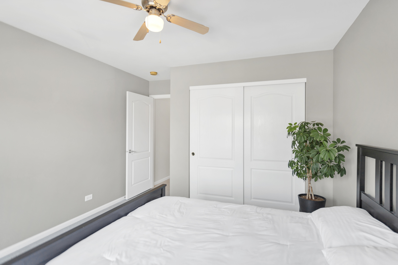 2574 Golf Ridge Circle Naperville, IL 60563 - Photo 26 of 29 a bedroom with a bed and a potted plant