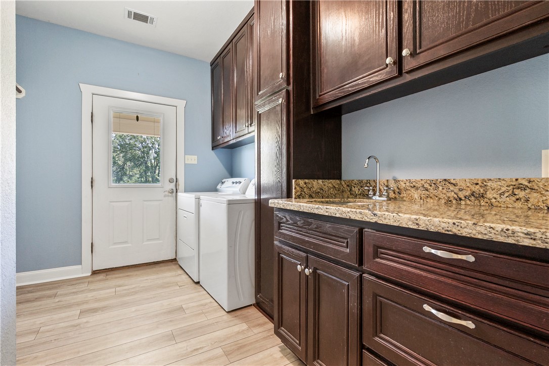 6701 Old Reliance Road Bryan, TX 77808 - Photo 21 of 44 a view of a kitchen cabinets and wooden floor