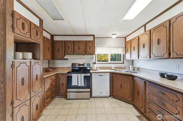 a kitchen with stainless steel appliances granite countertop a sink and cabinets