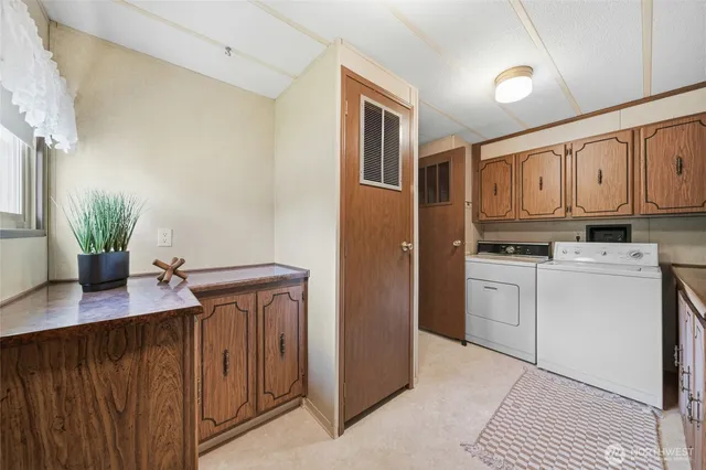 a kitchen with a refrigerator sink and cabinets