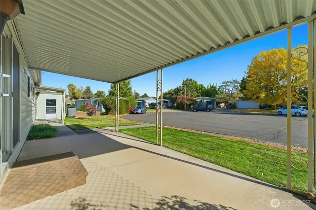 a view of an empty room with a fireplace and a window