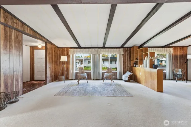 a large bedroom with a large bed and large windows with outer view