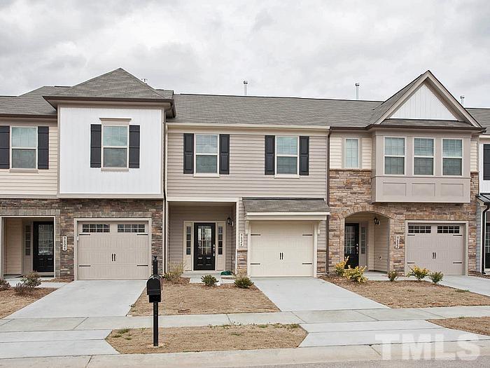1020 Grand Ridge Drive Rolesville, NC 27571 - Photo 1 of 23 a front view of a house with yard and parking space