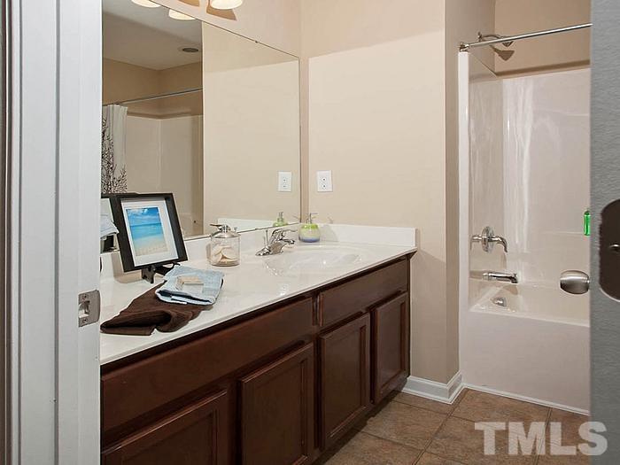 1020 Grand Ridge Drive Rolesville, NC 27571 - Photo 14 of 23 a bathroom with a sink a toilet and shower