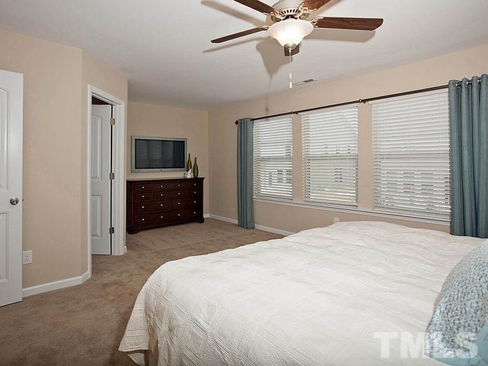 1020 Grand Ridge Drive Rolesville, NC 27571 - Photo 16 of 23 a bedroom with a bed and a flat screen tv