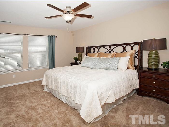 1020 Grand Ridge Drive Rolesville, NC 27571 - Photo 19 of 23 a bedroom with a bed and large window