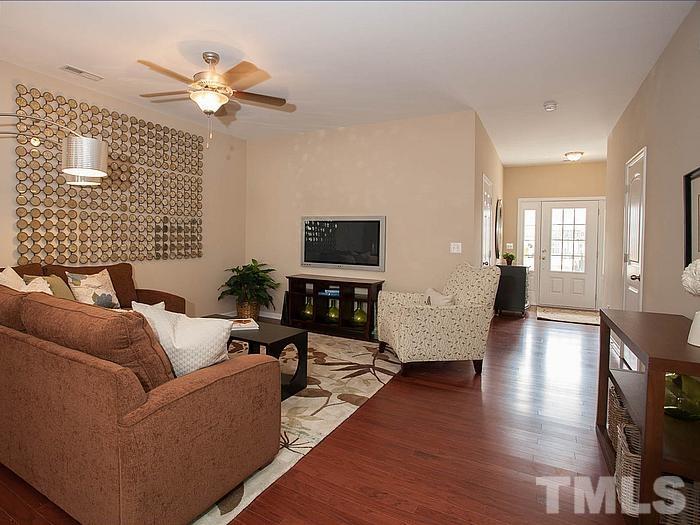 1020 Grand Ridge Drive Rolesville, NC 27571 - Photo 6 of 23 a living room with furniture wooden floor and a flat screen tv