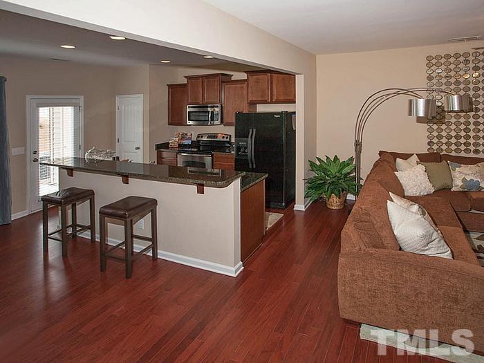 1020 Grand Ridge Drive Rolesville, NC 27571 - Photo 7 of 23 a kitchen with furniture wooden floor and a refrigerator