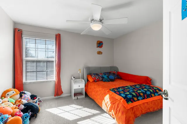 a bedroom with a bed and window