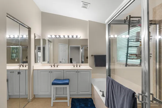 a large bathroom with a double vanity sink and a mirror