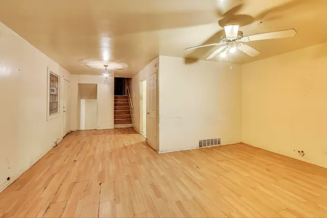 a view of empty room with wooden floor