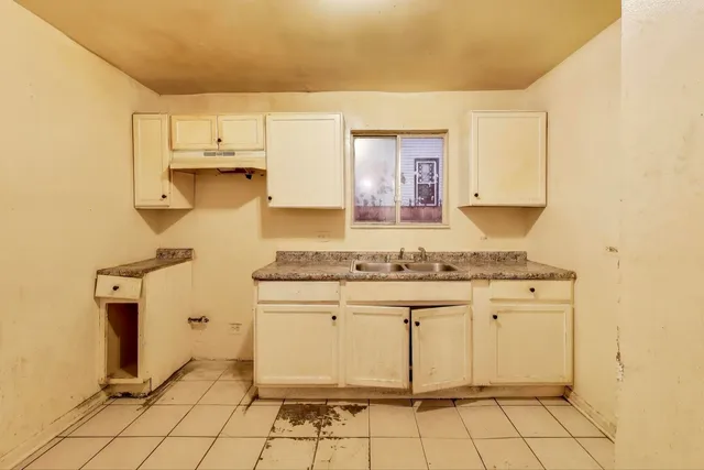 a kitchen with a sink cabinets and appliances