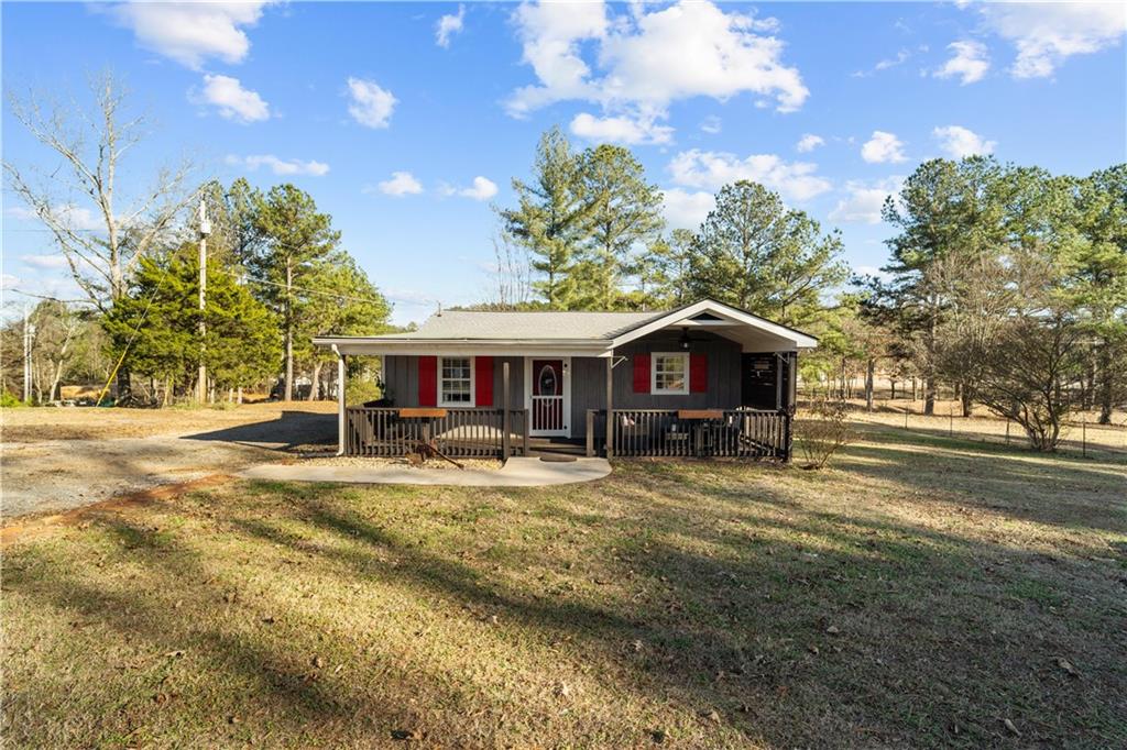 297 Tucker Hollow Road Southeast Calhoun, GA 30701 - Photo 1 of 42 a front view of a house with yard porch and livingroom
